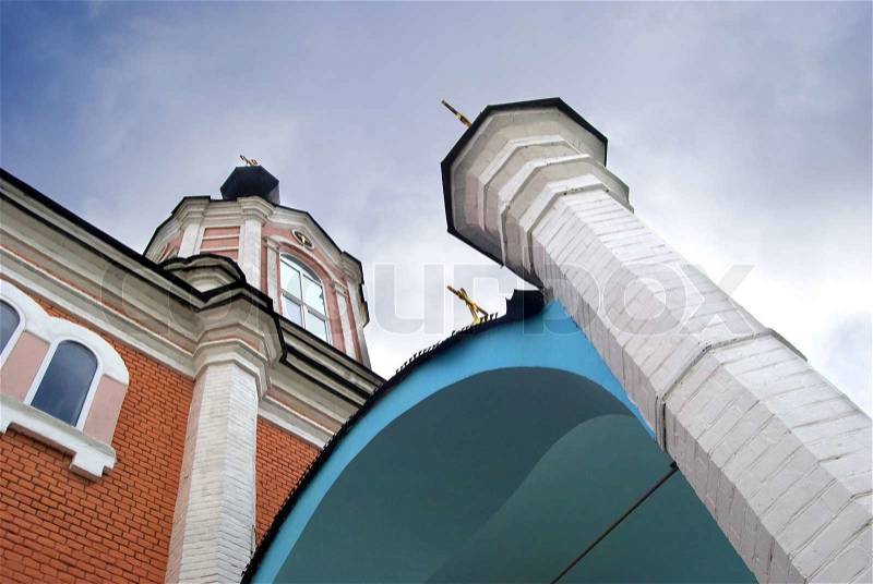 Orthodox church in the unusual perspective on the background of the sky and with the crosses on the domes, stock photo