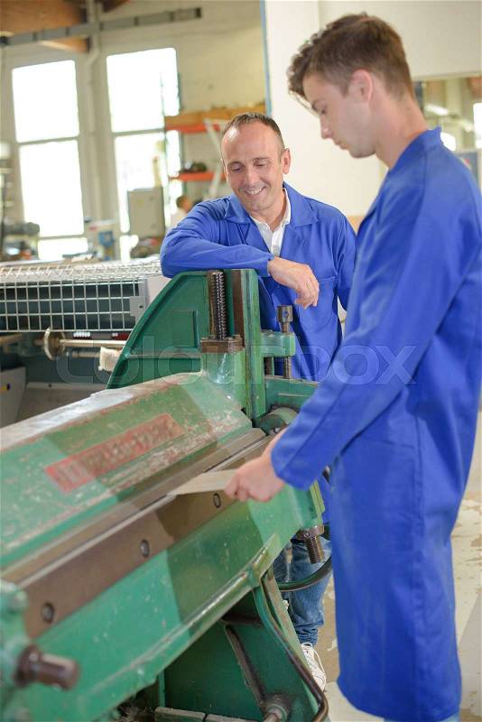 Student of the vocational school is working with mentor, stock photo