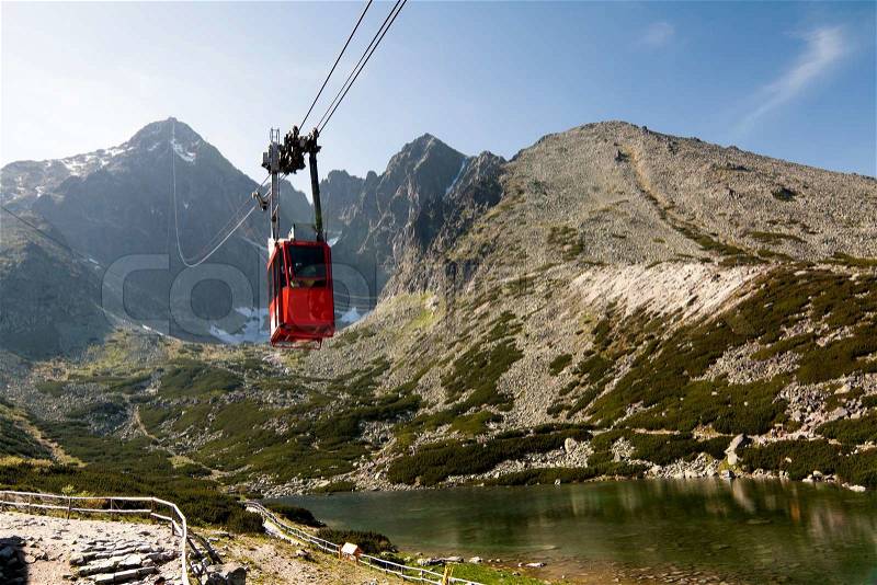 Red Mountain Cable Car with Mountain Range in Background, stock photo