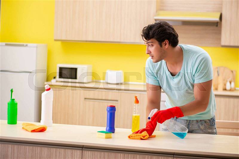 Young handsome man working in the kitchen , stock photo