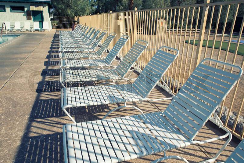 Deck chairs and swimming pool with filter effect, stock photo