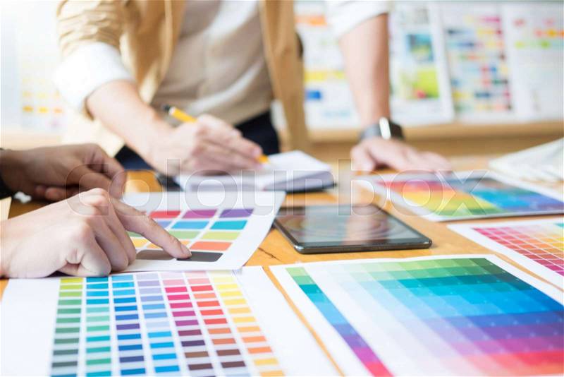 Creative Graphic designer at work. Color swatch samples pantone palette in studio modern office, interior design, renovation and technology concept, stock photo