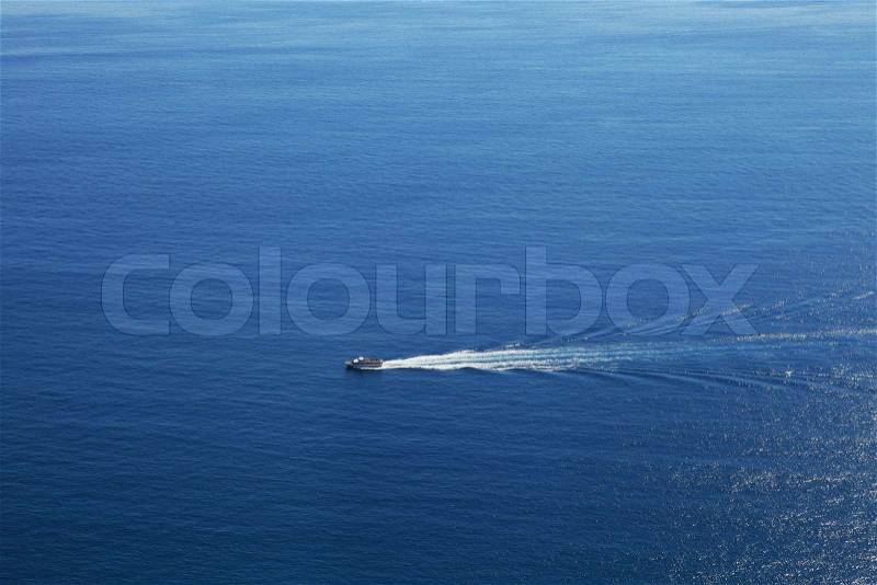 Aerial view on touristic cruise ship sailing on beautiful blue surface of Mediterranean sea in Northern Italy, stock photo