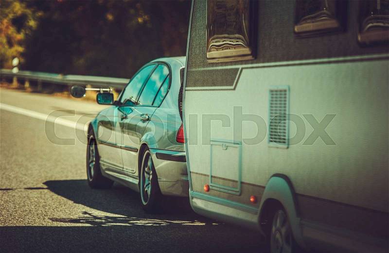 Compact Car with Travel Trailer on the Highway. Vacation Road Trip. Recreational Vehicle, stock photo
