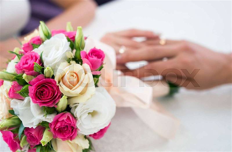 Beautiful wedding bouquet and hands. Bride\'s flowers, stock photo