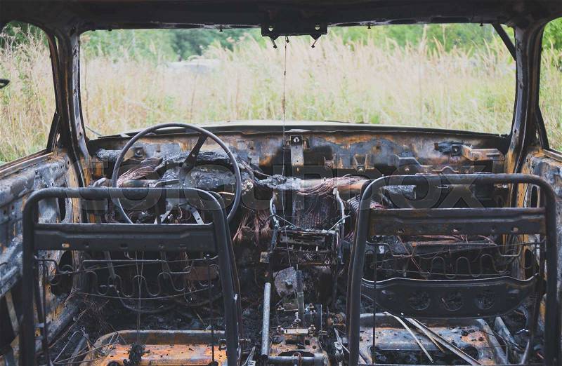 Burned out car after a car accident. Inside view, stock photo