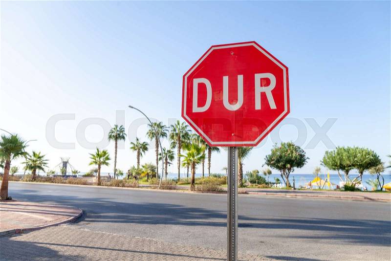 Turkish Stop sign on a street near the beach. DUR is the turkish word for stop, stock photo