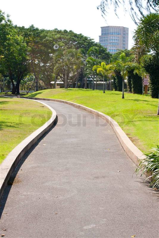 Winding path ahead is a tall building, stock photo