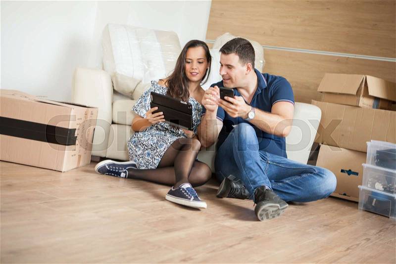 Smiling couple buying new furniture for their home. Couple relaxing in their new house, stock photo