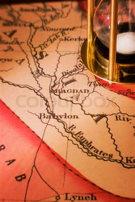 Very old map of Middle East showing Baghdad with sand timer. Concept of time running out. Lensbaby image with limited sharp zone, stock photo