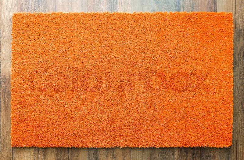 Blank Orange Welcome Mat On Wood Floor Background Ready For Your Own Text, stock photo