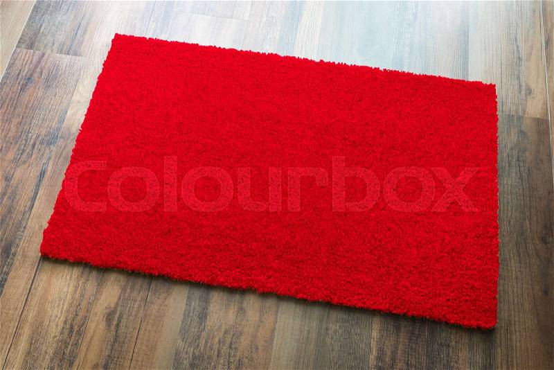 Blank Red Welcome Mat On Wood Floor Background Ready For Your Own Text, stock photo