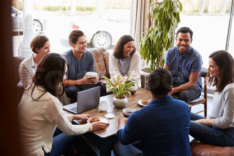 Group of friends having coffee together at a coffee shop, stock photo