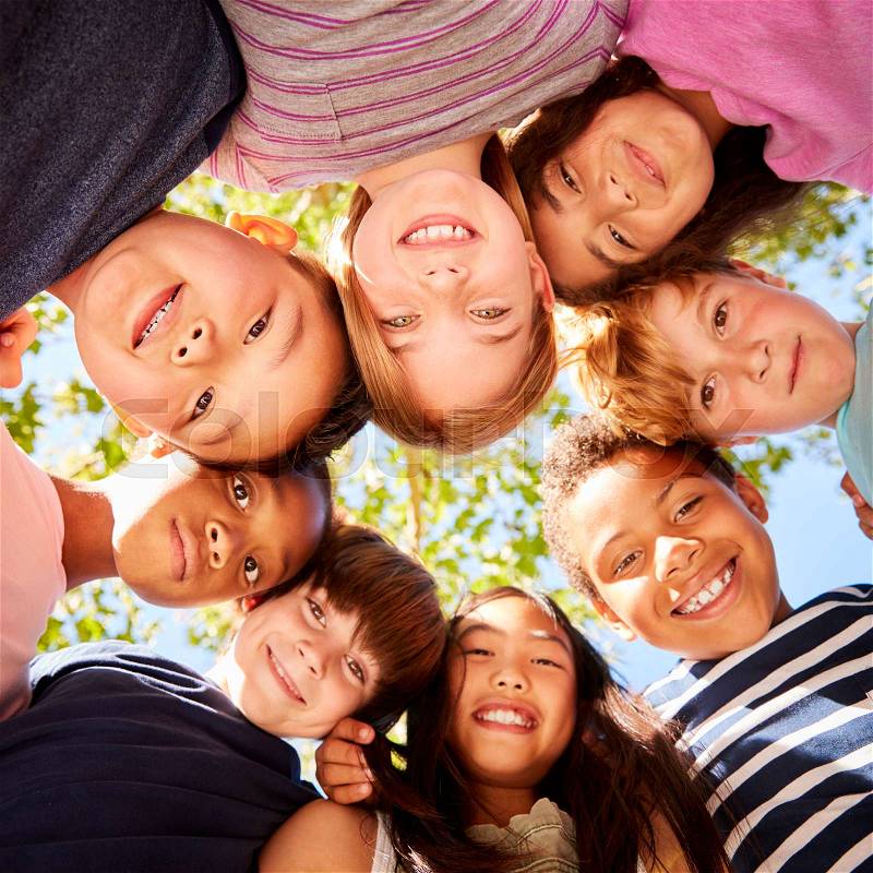 Group of kids outdoors looking down at camera, square format, stock photo