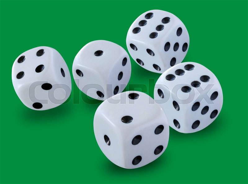Five white dices size thrown in a craps game, yatzee or any kind of dice game against a green background , stock photo