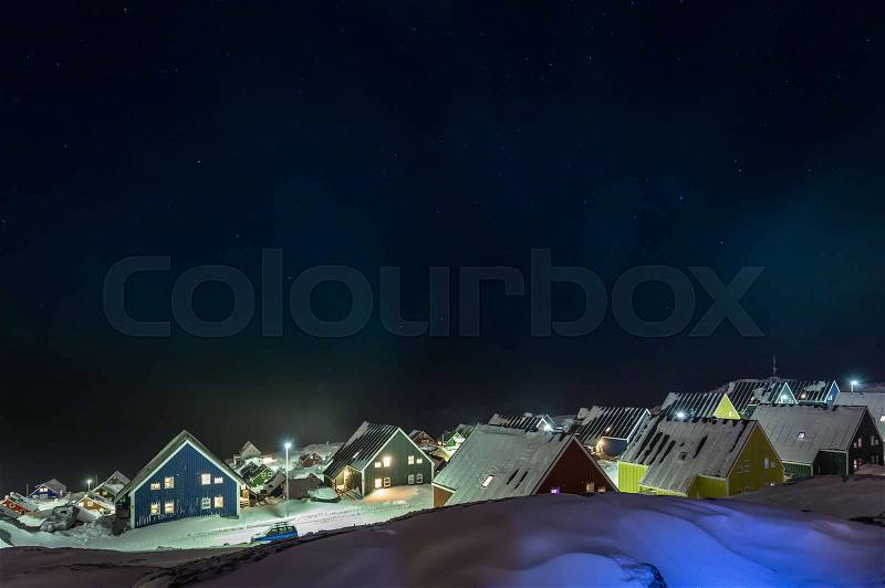 Arctic polar night over colorful inuit houses in a suburb of arctic capital Nuuk, Greenland, stock photo
