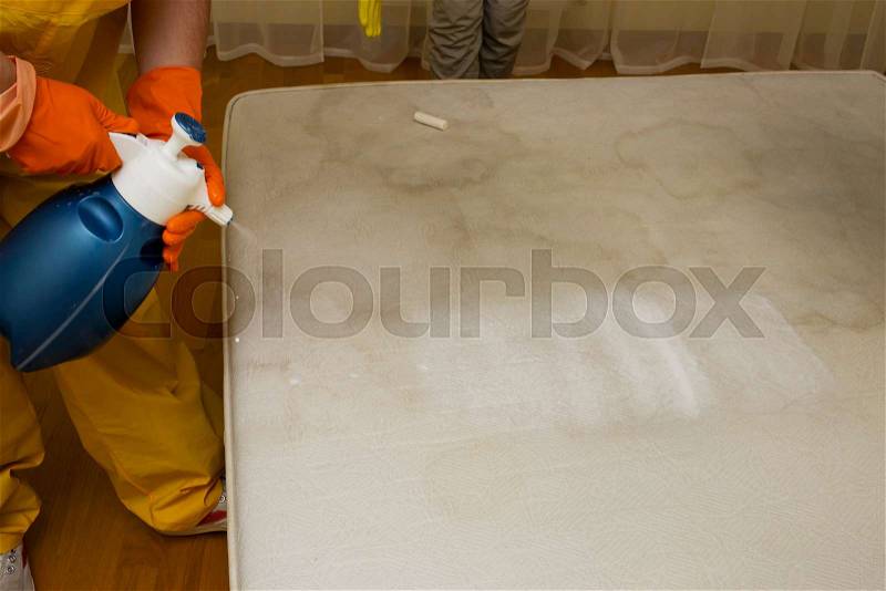 Dry cleaning of an old white mattress, stock photo