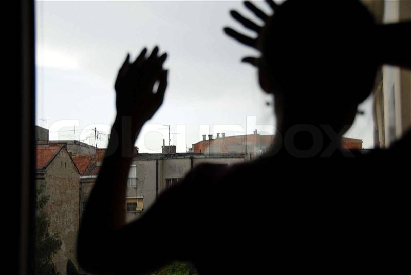 Female silhouette by window, stock photo
