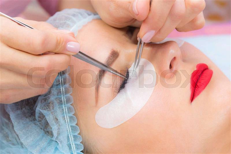 Woman on the procedure for eyelash extensions, eyelashes lamination, stock photo