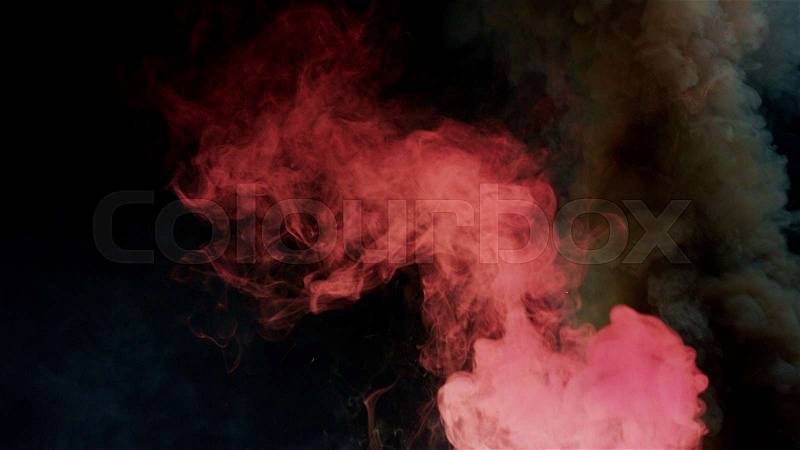Pink and black bomb smoke on black background, stock photo