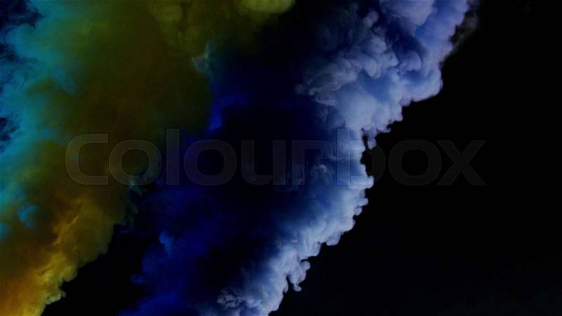Yellow and blue bomb smoke on black background, stock photo