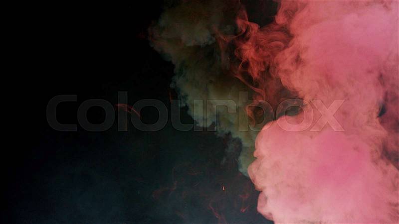 Pink and black bomb smoke on black background, stock photo