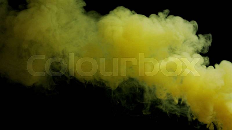 Yellow bomb smoke on black background, stock photo
