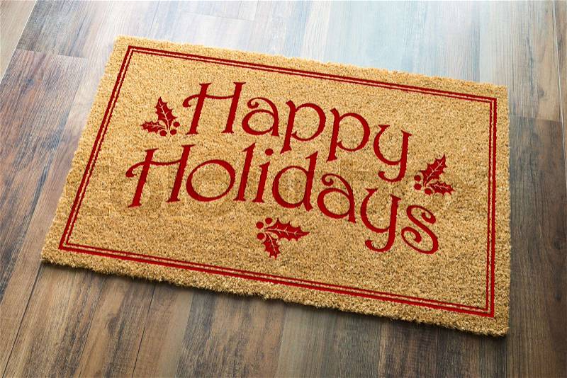 Happy Holidays Christmas Tad Welcome Mat On Wood Floor Background, stock photo