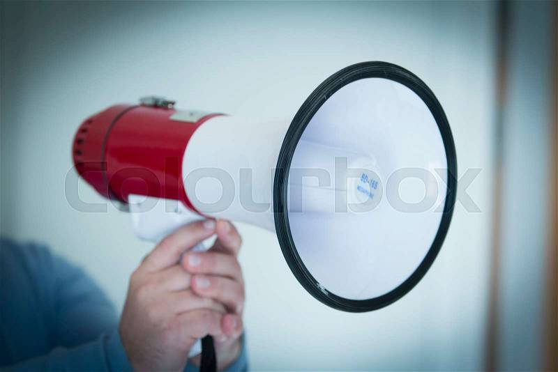 Man holding a loud speaker, stock photo