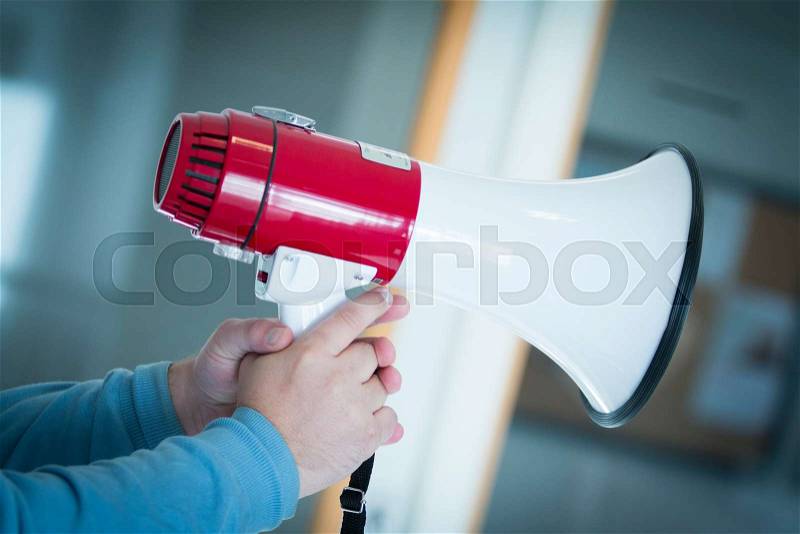 Man holding a loud speaker, stock photo