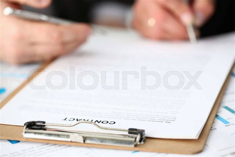 Male arm in suit and tie fill form clipped pad with silver pen closeup. Sign gesture read pact sale agent bank job make note loan credit mortgage investment finance ..., stock photo