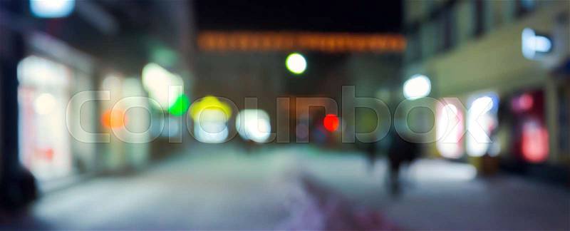 Panorama of night street in winter. city light and glowing shop windows. christmas sales concept. blurred background, stock photo