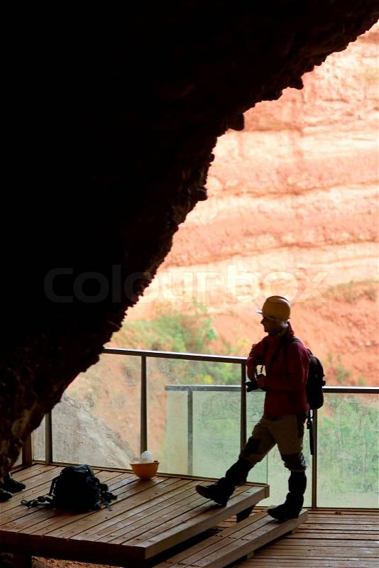 Man at cave, stock photo