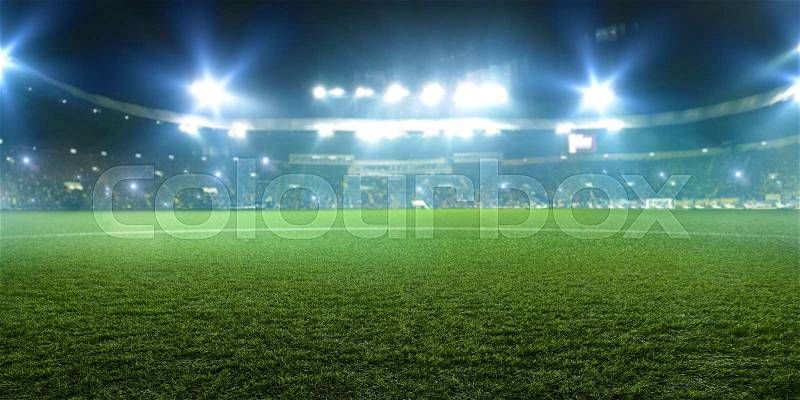 Football stadium, shiny lights, view from field grass. Turf, nobody on playground, tribunes with game fans on background, stock photo