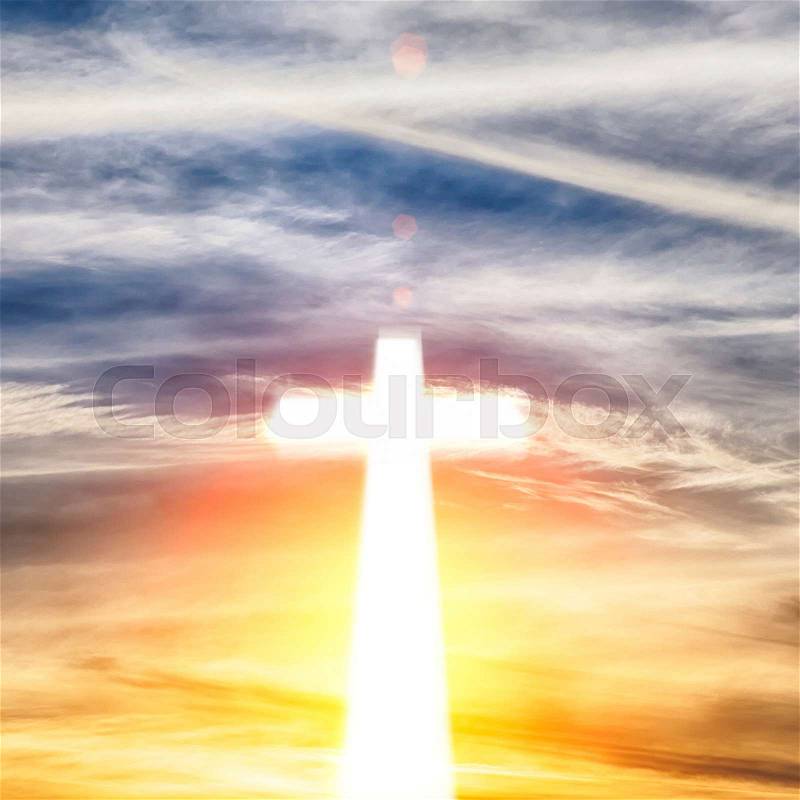 Glowing cross on beautiful sky background, stock photo