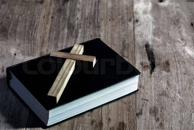 Close up cross on holy bible on wooden table. Christian concept. , stock photo