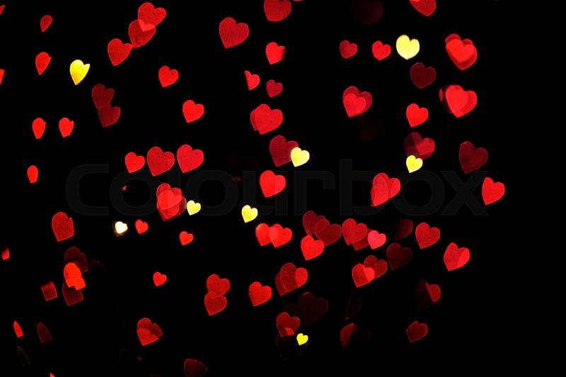 Defocused bokeh lights heart decoration. Abstract shiny love background, stock photo