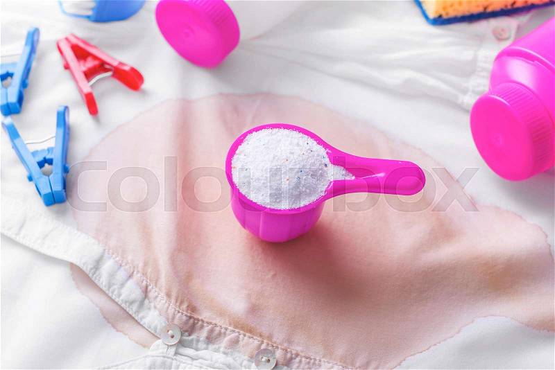 Stain on clothes. Stain removers and other cleaning supplies. Close-up, stock photo