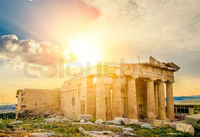 Glowing sun rays illuminate ancient Erechtheum temple ruins, Acropolis, Athens, Greece, stock photo