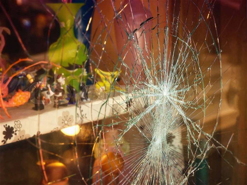 Broken shop window with color background, stock photo