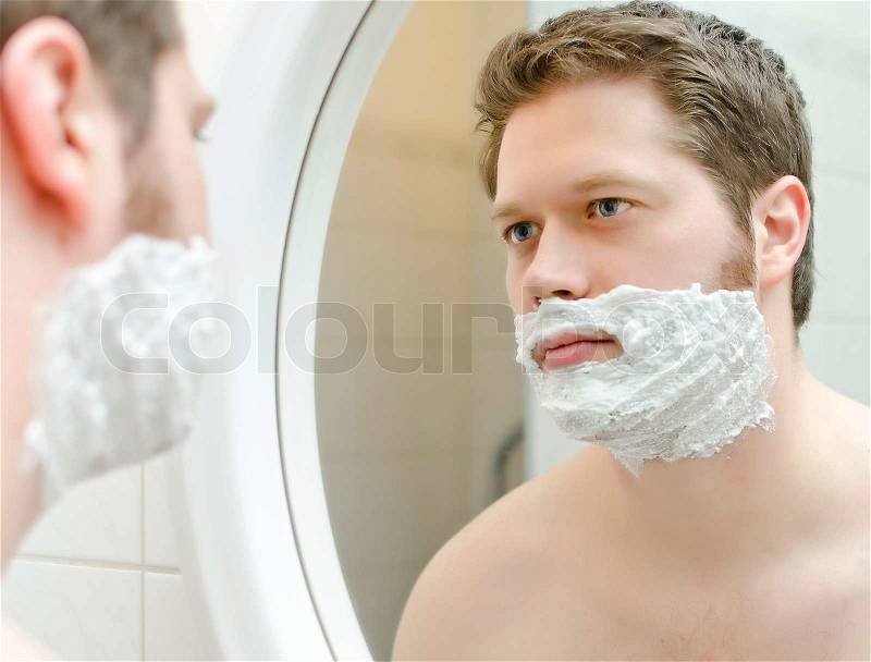 Man preparing to shave, foam on face, stock photo
