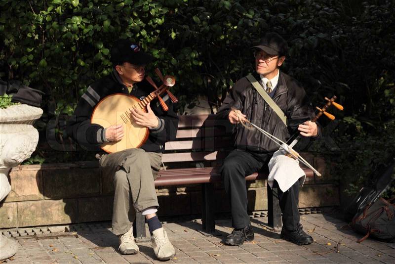Chinese Musicians playing Traditional instruments Players at People\'s Square in Shanghai Photo taken at 23rd of November 2010, stock photo