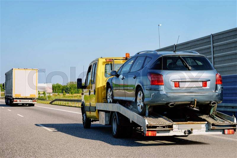 Tow truck transporter carrying car on the Road in Slovenia, stock photo