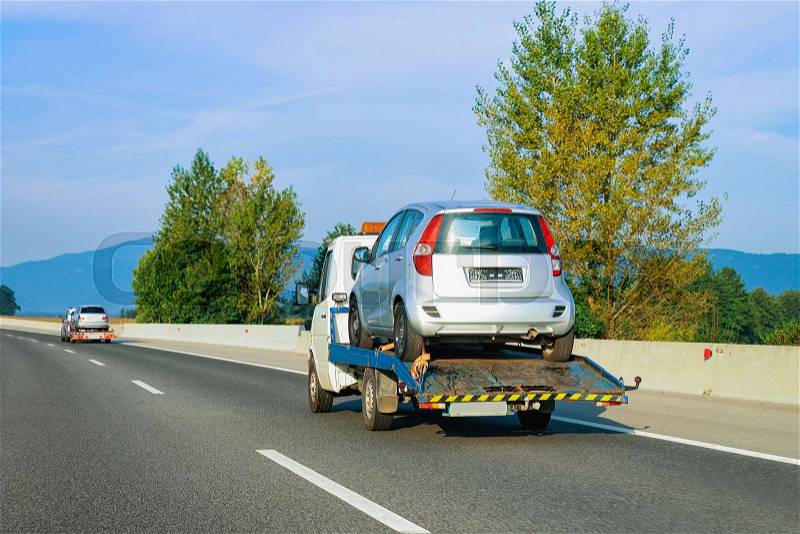 Tow truck transporter carrying car in the Road in Slovenia, stock photo