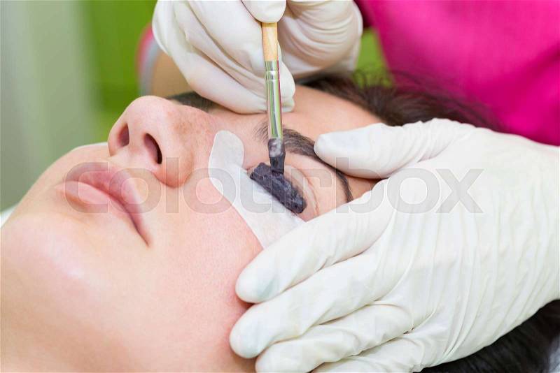 Woman on the procedure for eyelash extensions, eyelashes lamination, stock photo