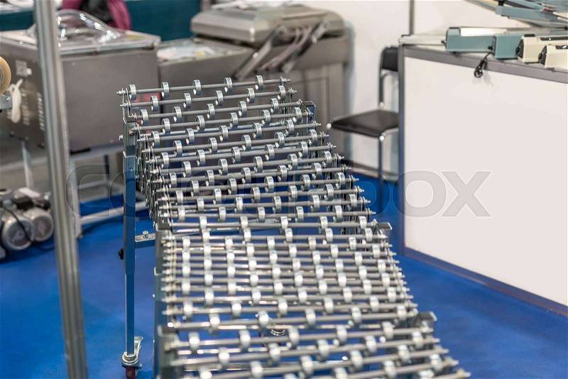 Flexible adjustable roller conveyor. Poratable innovative product\'s transportation technology for factory and logistic company, stock photo