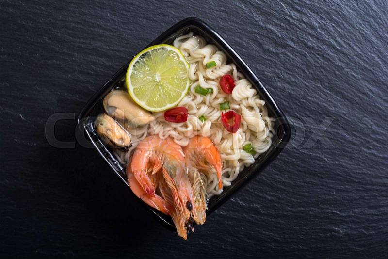 Instant noodles soup with shrimps and mssels . Asian food, stock photo