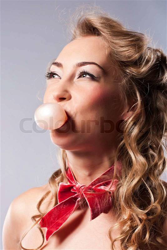 Pretty woman blowing bubble, with bubble gum, stock photo