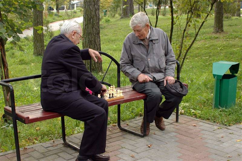 Two old men playing chess in the park 1, stock photo