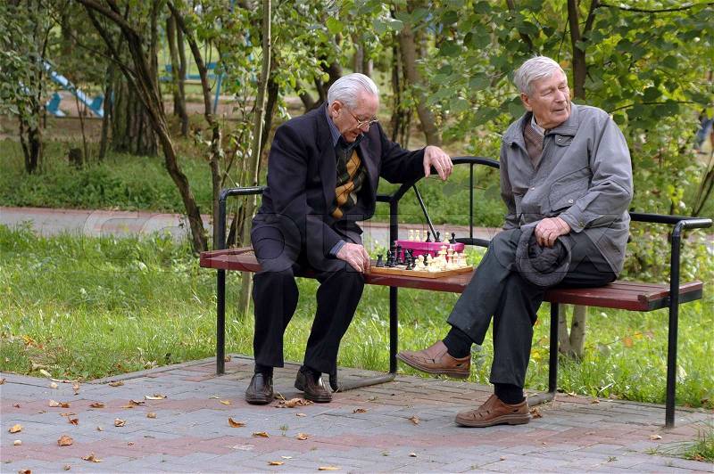 Two old men playing chess in the park 3, stock photo